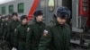 Russian conscripts called up for military service board a train as they depart for garrisons at a railway station in Omsk, Russia.