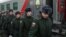 Russian conscripts called up for military service walk along a platform before boarding a train as they depart for garrisons at a railway station in Omsk. (file photo) 