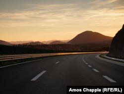 An empty section of the highway at sunset