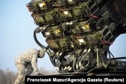 A U.S soldier inspects a Patriot missile launcher near Warsaw in 2015.