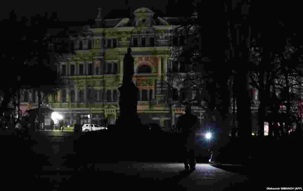 A man holds a flashlight during a blackout in the Ukrainian Black Sea city of Odesa on December 12.&nbsp;