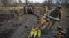 Ukrainian soldiers prepare cannon shells before firing them toward Russian positions in Donetsk region on January 1.