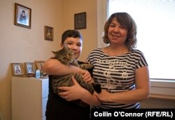 Nazar, Olha, and their new cat, Jack. In the background are Orthodox icons that Olha brought with her to Usti nad Labem when they fled from Kharkiv.