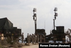 U.S. soldiers stand next to a radar component of a Patriot missile battery in Israel in 2012.