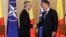 NATO Secretary-General Jens Stoltenberg (left) shakes hands with Romanian President Klaus Iohannis in Bucharest. (file photo)