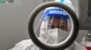 A health worker waits for people to take swab samples to test for the coronavirus in the Jing'an district in Shanghai on December 23.