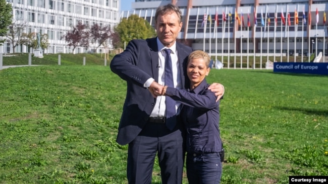 Guido Fluri (left), founder of the Justice Initiative at the Council of Europe, poses with Sirmanca Fechete, survivor of the Cighid orphanage. (Source: Justice-initiative.eu)