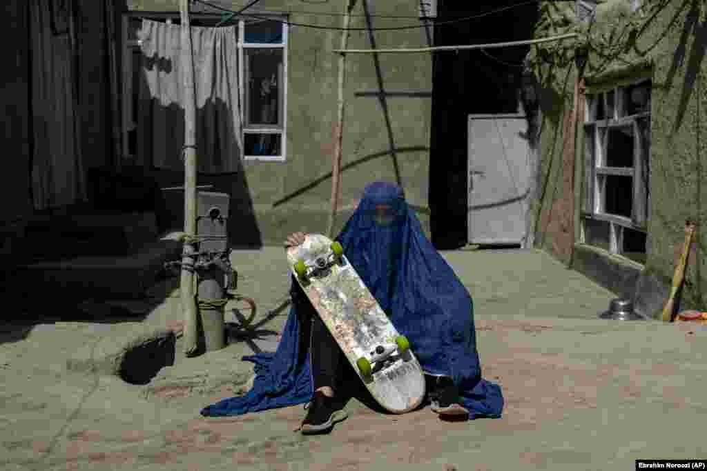An Afghan girl with her skateboard in Kabul. Under the Taliban, girls are barred from attending middle and high school. Last month, they ordered all women thrown out of universities, as well.
