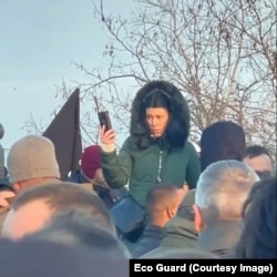 A photo taken by a protester during 2021 environmental protests in Serbia that allegedly shows plainclothes police using Huawei devices to film protesters without their permission.