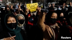 Afghan women chant slogans in protest at the closure of universities to women by the Taliban in Kabul in December 2022.