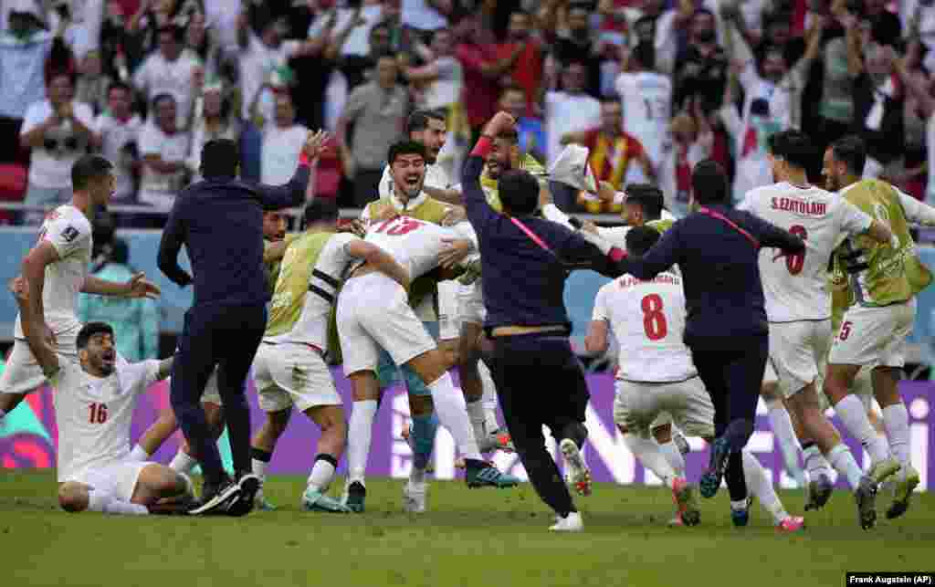 Iran&#39;s national soccer team celebrates Rouzbeh Cheshmi (center) after he scored the first goal in overtime during the World Cup Group B match between Wales and Iran, at the Ahmad Bin Ali Stadium in Qatar on November 25.