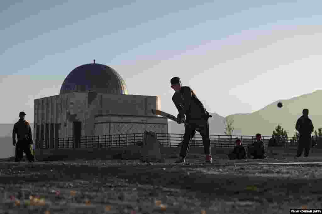 Afghan youth play cricket at the Nadir Khan hilltop.