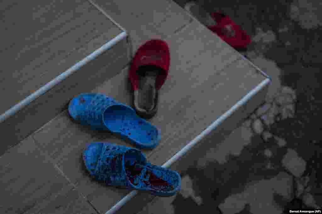 Blood-spattered slippers sit outside a house at the site of the shelling. Following the withdrawal of Moscow&#39;s forces across the Dnieper River, Russian artillery continues to indiscriminately maim and kill residents of Kherson.