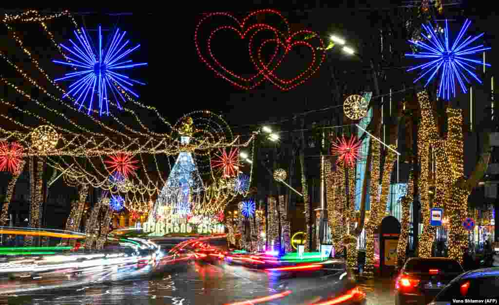 Cars drive past Christmas and New Year decorations in downtown Tbilisi on December 20.