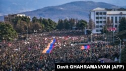 Nagorno-Karabakh - Protesters hold a giant Armenian flag as they attend a rally in Stepanakert, December 25, 2022. 