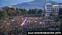 Nagorno-Karabakh - Protesters hold a giant Armenian flag as they attend a rally in Stepanakert, December 25, 2022.