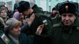 Russian conscripts called up for military service say goodbye to relatives at a railway station in Omsk in November 2022. 