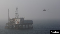 A helicopter lands on an oil platform in the Caspian Sea, east of Baku, January 22, 2013