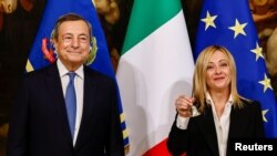 Giorgia Meloni első kormányülése kezdetét jelzi a csengővel elődje, Mario Draghi mellett a Chigi-palotában, Rómában 2022. október 23-án
