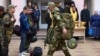 Mobilized men are seen at a gathering station set up in a cultural center in the town of Bataisk in southwestern Russia.