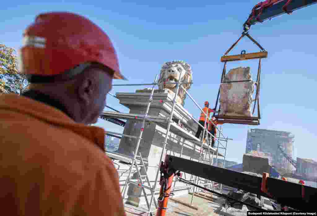 One of the stone lions being returned to its pedestal on October 18. The stone lions each weigh a reported 12 tons -- around the weight of a public transport bus. &nbsp;