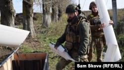 Ukrainian drone operators "Guard" and "Kim" pack up a drone in the Kharkiv region on October 22.