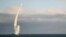 A Russian warship launches a cruise missile at a target in Ukraine.