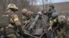 Ukrainian servicemen prepare to fire a mortar near the front line in eastern Ukraine. (file photo)