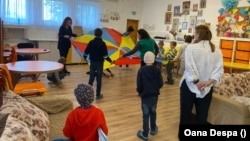 Younger children take part in a game to develop motor skills at an orphanage in Romania that has been repurposed to house Ukrainian kids with disabilities. 