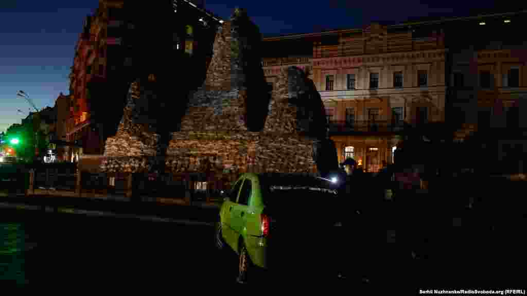 A man uses his mobile phone&#39;s light to find his way along a darkened street in Kyiv on October 19. &ldquo;These are war crimes,&rdquo; European Commission President Ursula von der Leyen said on October 19. &ldquo;Targeted attacks on civilian infrastructure with the clear aim to cut off men, women, children [from] water, electricity, and heating with winter coming. These are acts of pure terror.&rdquo;