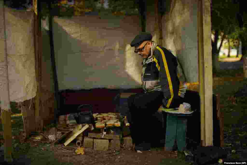 Makeshift lean-to structures dot the overgrown courtyards of apartment complexes where Anton Sevrukov, 47, toasts bread and heats a kettle of water over a fire to bring tea to his disabled mother.