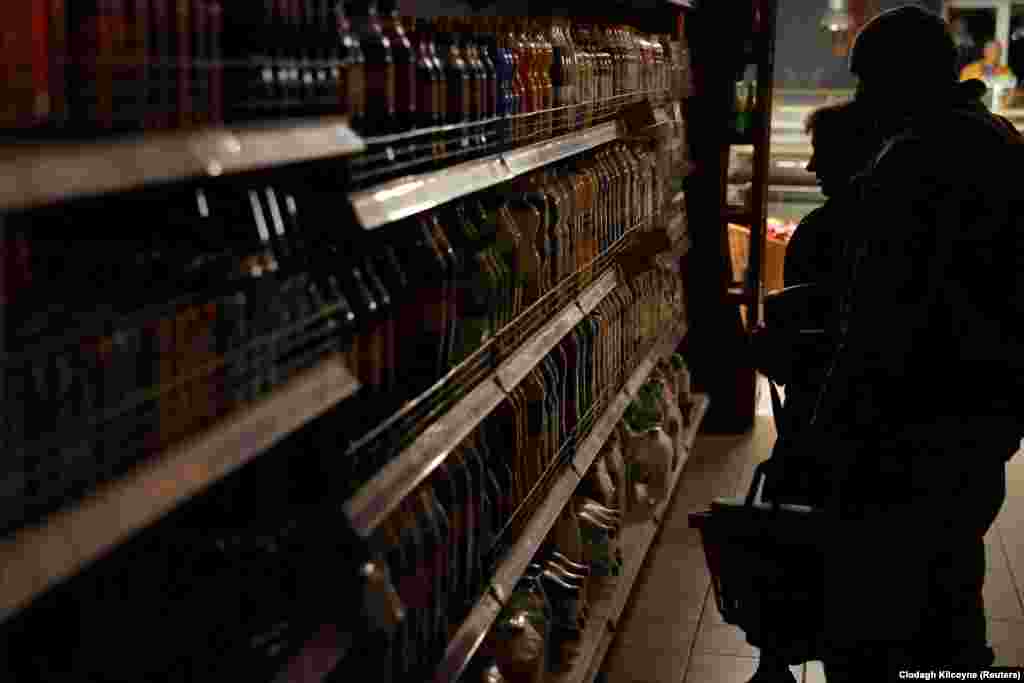 People shop in a supermarket in Kharkiv during a power outage on October 17. Ukrainian authorities have called Moscow&#39;s tactic of targeting civilian infrastructure a war crime and continue their call for Russia to be designated a state sponsor of terrorism.