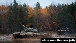 Ukrainian soldiers drive captured Russian T-72 tanks as part of military training close to the Belarusian border on October 28.