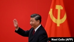 China's Xi Jinping waves after introducing the members of the Chinese Communist Party's new Politburo Standing Committee, the country's top decision-making body, in the Great Hall of the People in Beijing on October 23, 2023.