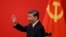 Chinese President Xi Jinping waves after introducing the members of the Chinese Communist Party's new Politburo Standing Committee, the country's top decision-making body, in the Great Hall of the People in Beijing on October 23.