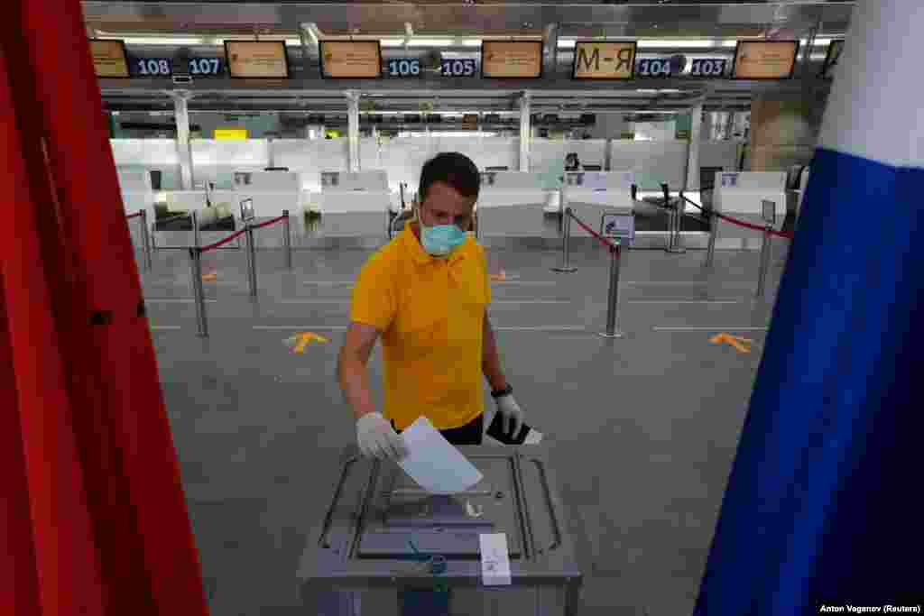 A man casts his ballot at a polling station created at Pulkovo International Airport in St. Petersburg on June 25.&nbsp;Authorities opened polling stations a week early and are letting voters cast ballots over a seven-day period to stop overcrowding amid the coronavirus pandemic.