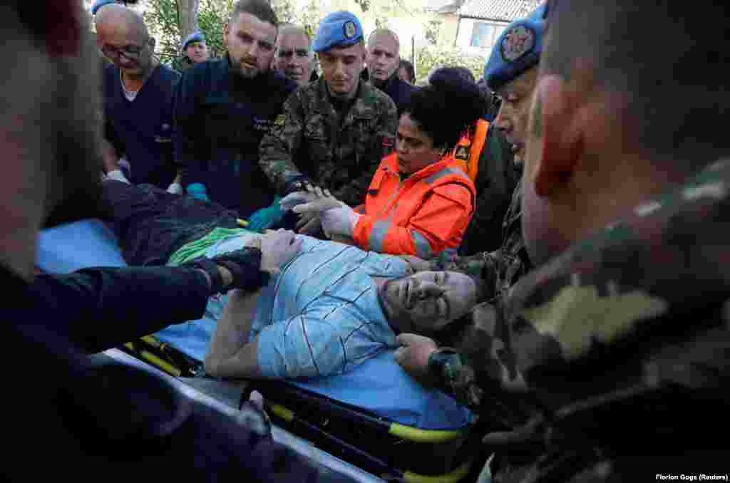 A survivor being pulled from the rubble in Thumane.