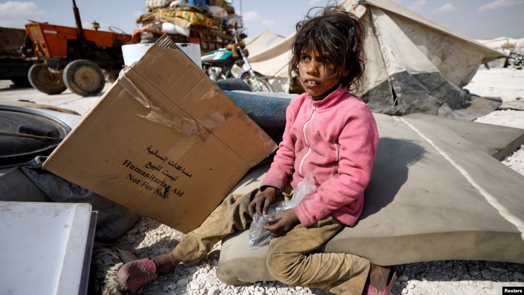 An internally displaced girl who fled Raqqa city sits inside a camp in Ain Issa, in Raqqa Governorate, on May 4.