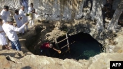 Mayan priests hold a water-blessing ceremony at the Noc Ac cenote, a natural deep deposit of water, in Yucatan, Mexico, on December 15 within the framework of a cultural festival to celebrate the end of the Mayan calendar.