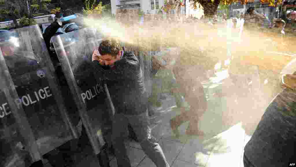The leader of the Kosovo nationalist opposition Self-Determination movement, Albin Kurtin, is sprayed with tear gas by police during a protest in Pristina. (AFP/Armend Nimani)