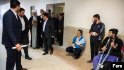 Iran's prosecutor general visiting Fashafuyeh Prison near Tehran as some detained protesters are seen on the right. November 24, 2019