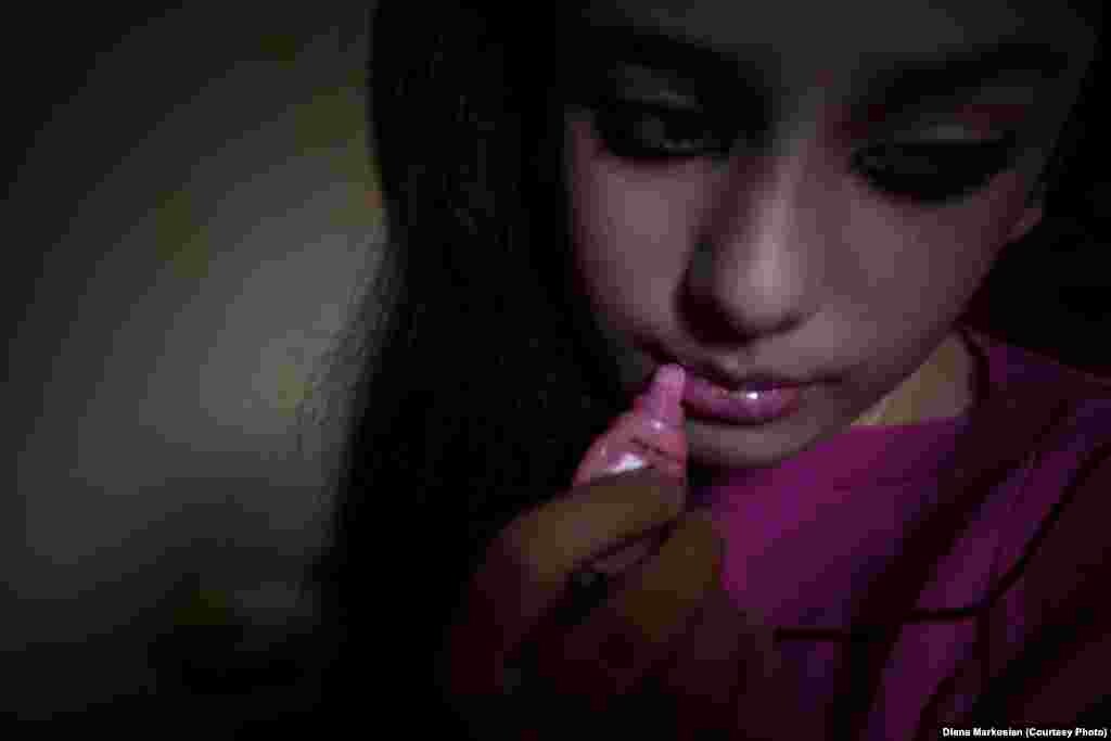A Chechen teen, who identifies herself as "emo," puts on pink lipstick in her bedroom. Chechen youths influenced by the Western emo subculture have frequently been subjected to official harassment and violence.