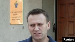 Aleksei Navalny speaks to the media outside the Federal Investigation Commission building in Moscow on June 13.