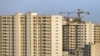 This July 6, 2019 photo shows residential towers in District 22, that consists of apartment high-rises and shopping malls arranged around an artificial lake called Chitgar, under construction on the northwestern edge of Tehran, Iran (AP Photo/Ebrahim Noro