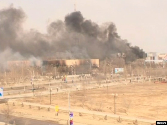 Clouds of smoke rise from the restive Kazakh town of Zhanaozen in this still image taken from video acquired by Reuters TV on December 16, 2011.