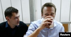 Aleksei Navalny (right) and his brother and co-defendant Oleg attend a court hearing in Moscow on December 19.
