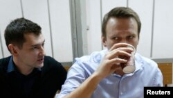 российский оппозиционный политик Алексей Навальный (справа) и его брат Олег во время судебного процесса. Москва, 19 декабря 2014 года. 