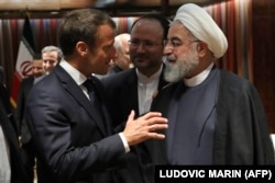 French President Emmanuel Macron (L) and Iranian President Hassan Rouhani speak at the United Nations headquarters on September 23, 2019, in New York.