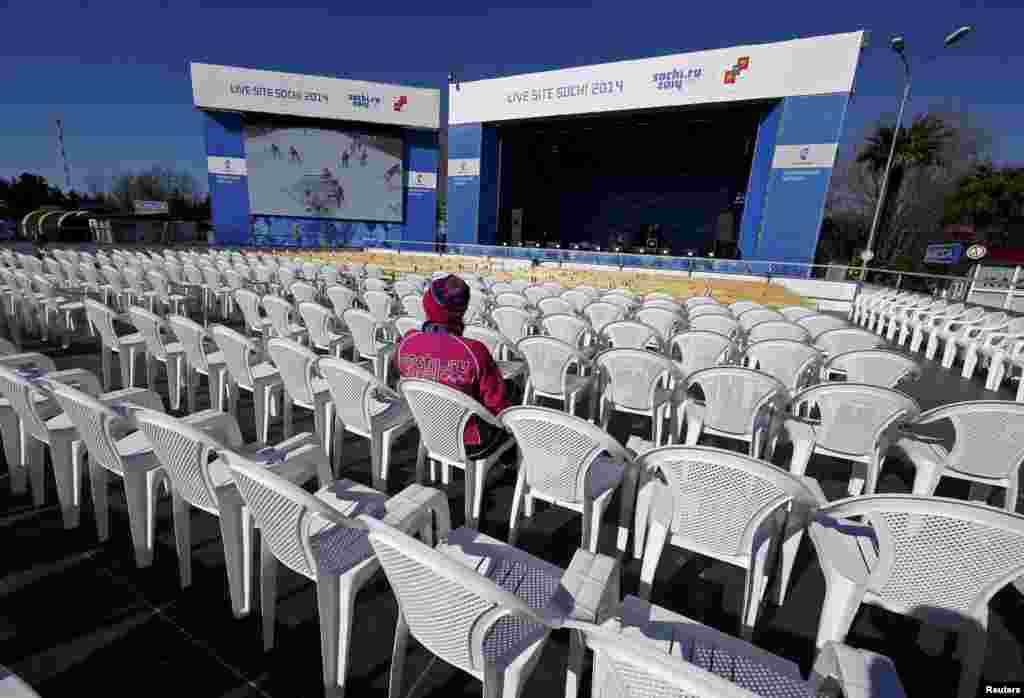 A spectator watches an ice hockey game on a giant television screen in Sochi&#39;s Adler district.&nbsp;