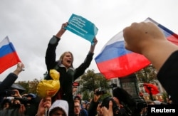 Supporters of Russian opposition leader Aleksei Navalny attend a rally in Moscow. The sign reads: "Freedom of elections, freedom to Navalny"